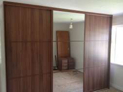 Dark walnut and mirror doors divided into 3 equal splits giving an oreiental feel