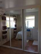 3 mirror sliding doors with white frames