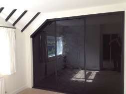 Black glass doors with a floral pattern on the middle door